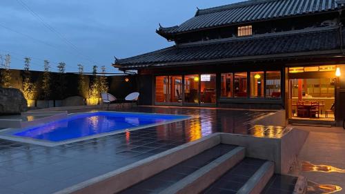 a house with a swimming pool in front of a building at Awajishima dog stay,YAGI - Vacation STAY 93054v in Minamiawaji
