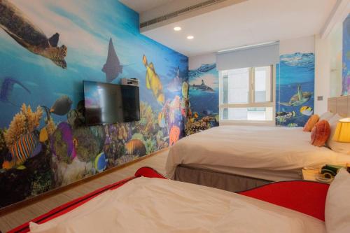 a bedroom with two beds and a mural at Muen Yuan Dong Hot Spring Hotel in Jiaoxi