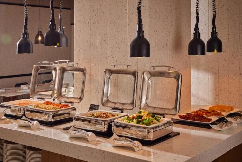 a buffet line with many different dishes of food at Four Points by Sheraton Shenzhen Bao'an in Shenzhen