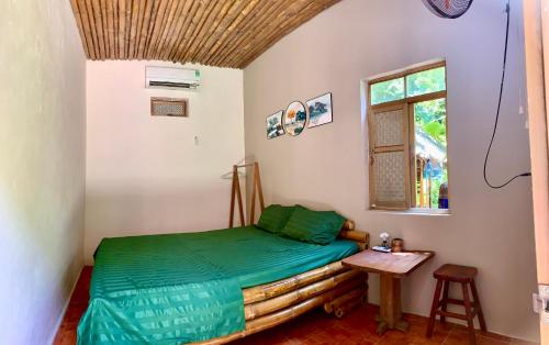 a small bedroom with a bed and a window at Mai Chau Home Holiday in Mai Chau