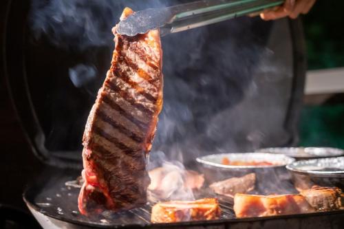 a piece of meat cooking on a grill at Marinetopia The Suite in Miyazu