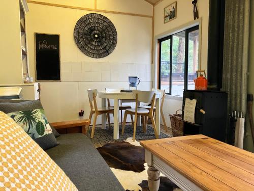 a living room with a table and a dining room at Golden Bay Glamping in Takaka