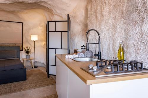 a kitchen with a sink and a counter top at Redrock Riverside Cave 3 - Glamping Cave Suite in Moab