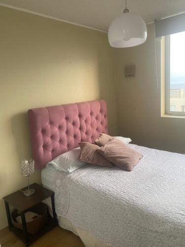 a pink bed with two pillows on it in a bedroom at Linda Habitación Individual con Baño compartido, TV e Internet de Alta Velocidad Cerca al Aeropuerto y a la Arena 1 in Lima
