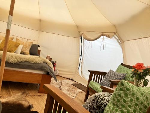 - une chambre avec un lit dans une tente dans l'établissement Golden Bay Glamping, à Takaka