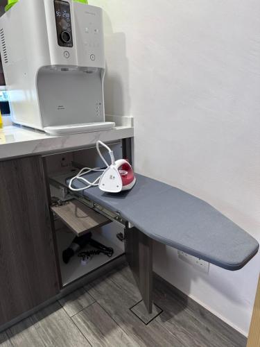 a desk with a computer monitor and a mouse on it at Rumah Tamu Sonata in Seremban