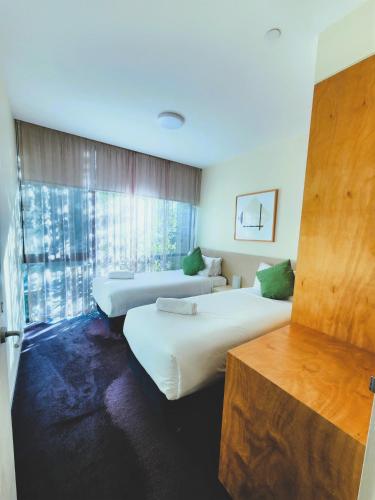 a hotel room with two beds and a window at Phillip Island Apartments in Cowes