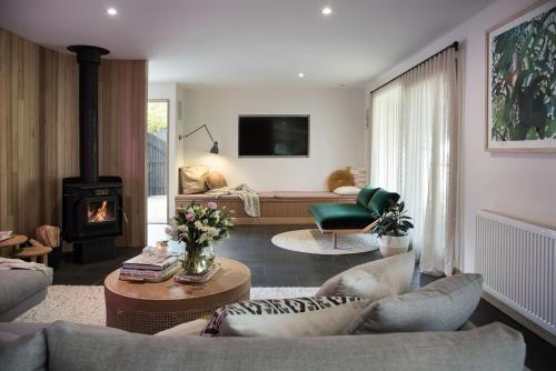 a living room with a couch and a fireplace at Dollywood in Daylesford