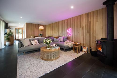 a living room with a couch and a fireplace at Dollywood in Daylesford