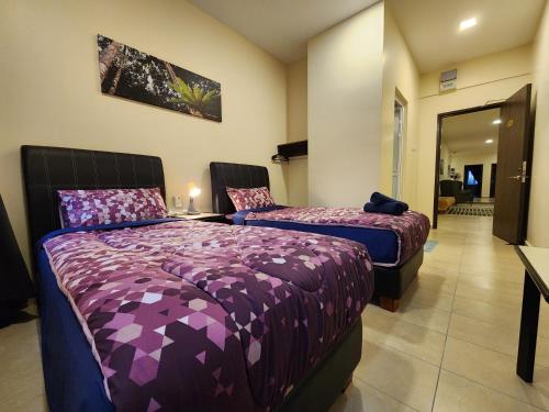 a hotel room with two beds and a mirror at Fathers Guesthouse Age 7 years old and above only in Tanah Rata