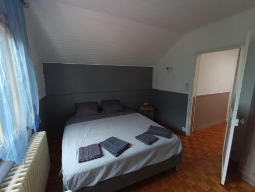 a bedroom with a bed with two pillows on it at La rose de Provins in Provins
