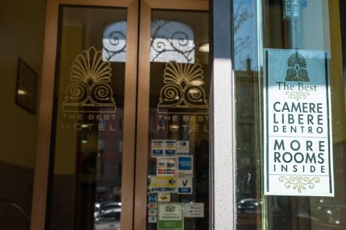 a store front door with a sign on it at The Best Hotel in Milan