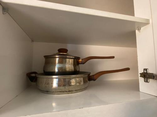 a pot sitting on top of a stove in a kitchen at Comfy 2 Bedroom Apartmen Pavilion Permata Surabaya in Dukuhpakis