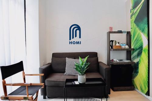 a living room with a couch and a table at Homi Oasis at KK Times Square 和逸绿洲 in Kota Kinabalu