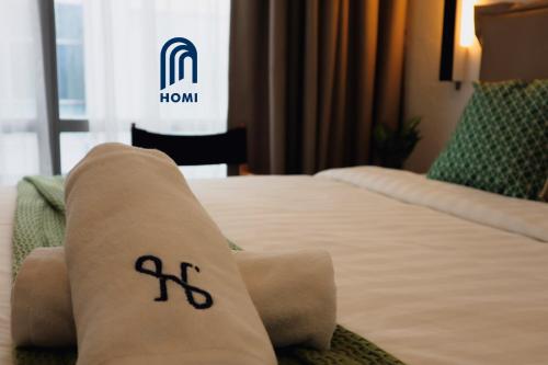 a close up of a bed in a hotel room at Homi Oasis at KK Times Square 和逸绿洲 in Kota Kinabalu
