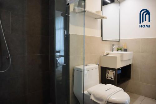 a bathroom with a toilet and a sink and a shower at Homi Oasis at KK Times Square 和逸绿洲 in Kota Kinabalu
