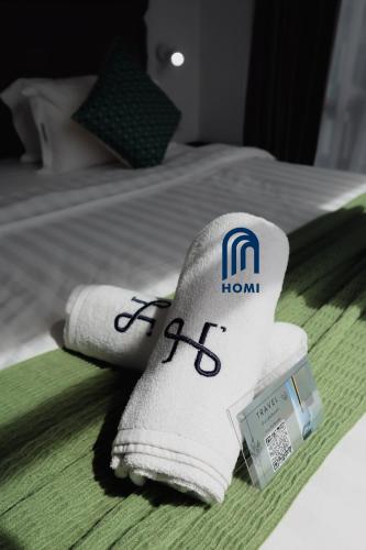 a hotel room with towels on a bed at Homi Oasis at KK Times Square 和逸绿洲 in Kota Kinabalu