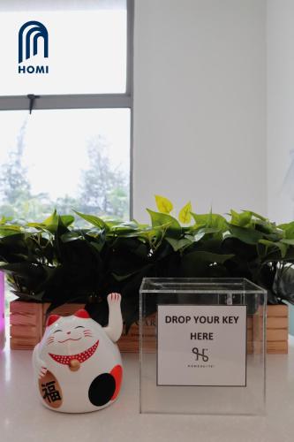 a sign that says drop your key here next to a toy at Homi Oasis at KK Times Square 和逸绿洲 in Kota Kinabalu