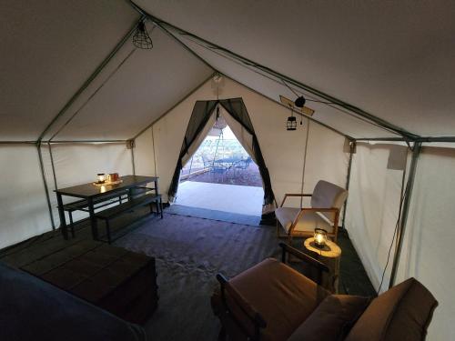 an interior of a tent with a table and chairs at Prairie Falcon in Valle
