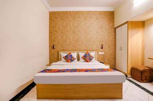 a bedroom with a large bed in a room at FabHotel Heritage Palace in Aurangabad