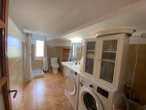 a bathroom with a washer and dryer in it at Casa Cal Duc, la Garriga in La Garriga