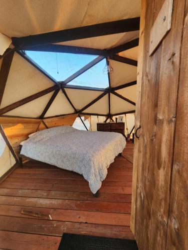 a room with a bed in a tent with a window at Sova in Valle