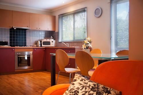 a kitchen with a table and chairs in a room at Eastern View Villa in Daylesford