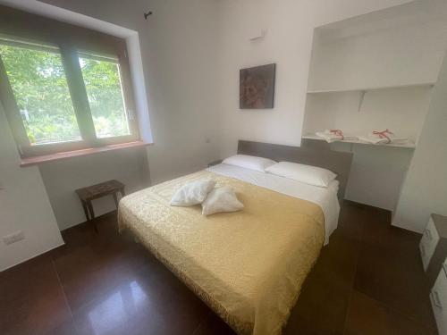 a bedroom with a bed and a window at Villa Romina in Selva di Fasano