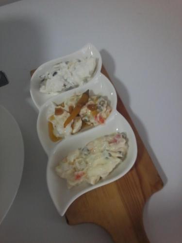 three plates of food on a wooden table at Dream Stone Holiday Bar Restaurant in Polje