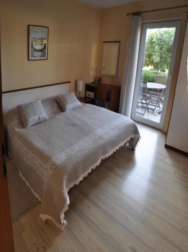 a bedroom with a bed and a sliding glass door at Villa Bakica in Trogir