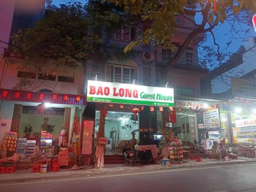 a store with a sign for a bag long guest house at Bao Long Guest House in Cat Ba