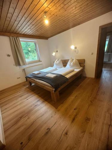 a bedroom with a bed in a room with a wooden ceiling at Haus Stille Oase in Bruck an der Großglocknerstraße