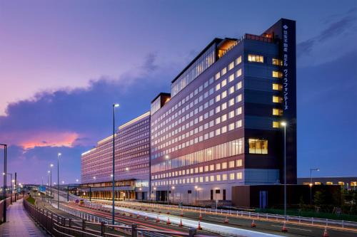 a large building with lights in front of it at Villa Fontaine Premier Haneda Airport in Tokyo