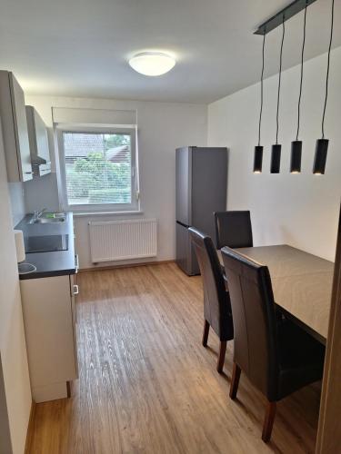 a kitchen and dining room with a table and chairs at Guesthouse Flower in Ljubljana