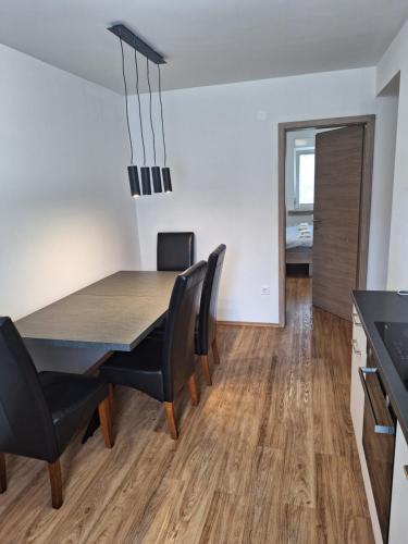 a dining room and kitchen with a table and chairs at Guesthouse Flower in Ljubljana