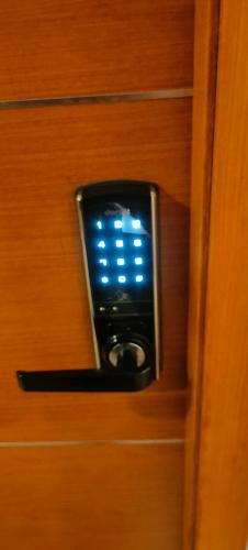 a close up of a door with a blue light on it at Luxurious Apartment with a pool and gym near Trivandrum railway station in Trivandrum