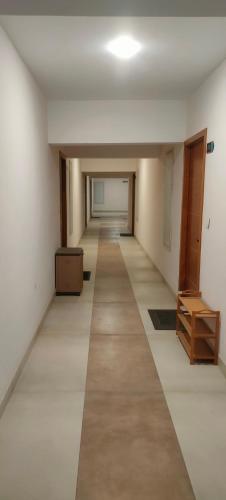 an empty hallway in an office building with a room with a door at Luxurious Apartment with a pool and gym near Trivandrum railway station in Trivandrum
