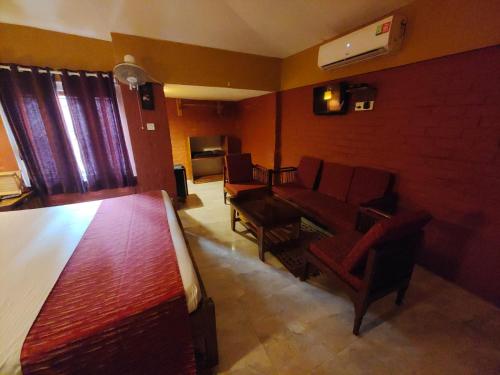 a living room with a couch and chairs in it at Wild Dunes Konark in Bālighāi