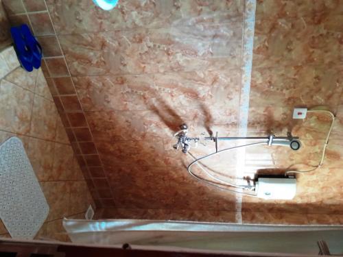 a bathroom with a sink and a toilet paper dispenser at Olina Hotel and Apartments Kampala in Kampala
