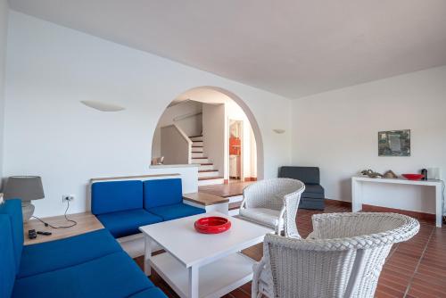 a living room with a blue couch and chairs at Holiday Home Zaton in Dubrovnik