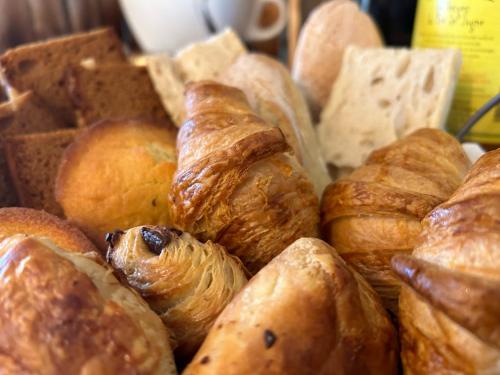 a bunch of different types of breads and pastries at Le Domaine de la Claire Fontaine Gîtes -chambres d'hôtes in Montvalent