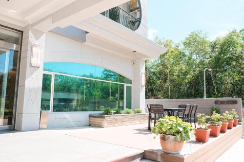 a patio with chairs and plants on a building at Hoping Mori Hotel in Heping