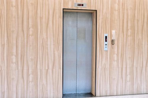 a glass door of a building with a phone at Hoping Mori Hotel in Heping