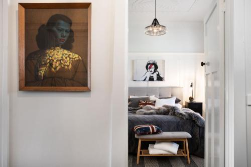 a bedroom with a bed and a painting on the wall at Fontaine in Daylesford