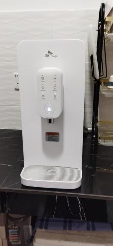 a white appliance sitting on top of a counter at Homestay Teratak Ibunda in Jerantut