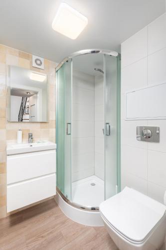 a bathroom with a shower with a toilet and a sink at Świętokrzyska 16 (E-G) by Homeprime in Warsaw