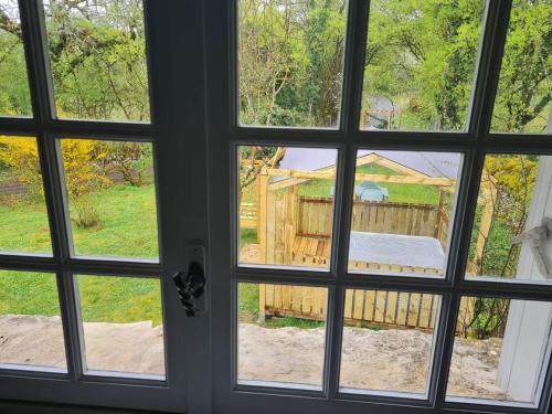 a view through a window of a yard at Le Domaine de la Claire Fontaine Gîtes -chambres d'hôtes in Montvalent