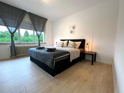- une chambre avec un lit et une grande fenêtre dans l'établissement Gemütliche Wohnung mit Stil 5 Sterne, à Mönchengladbach
