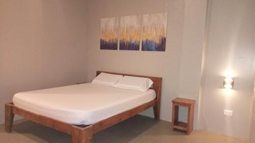 a small bedroom with a bed with white sheets at Hope Pension House - Liloan in Liloan