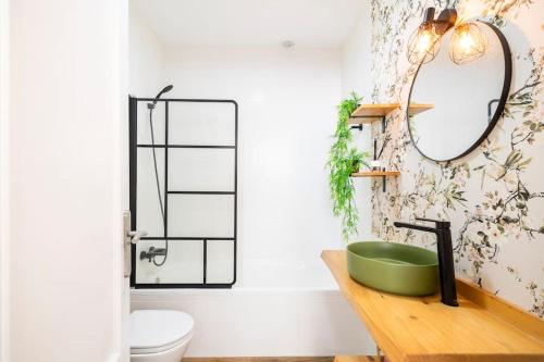 a bathroom with a green sink and a mirror at Azahar house in Formentera del Segura